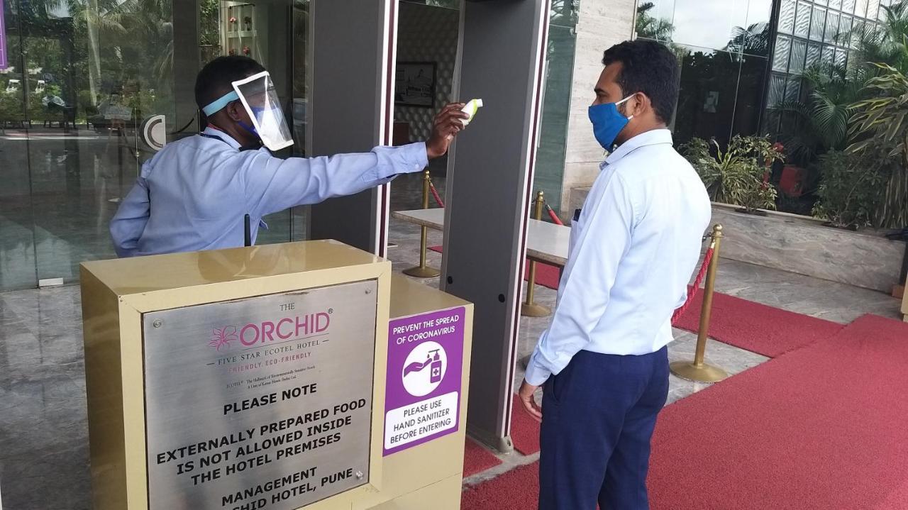 The Orchid Hotel Hinjewadi Pune Exterior foto Temperature check at the entrance of a hotel in India